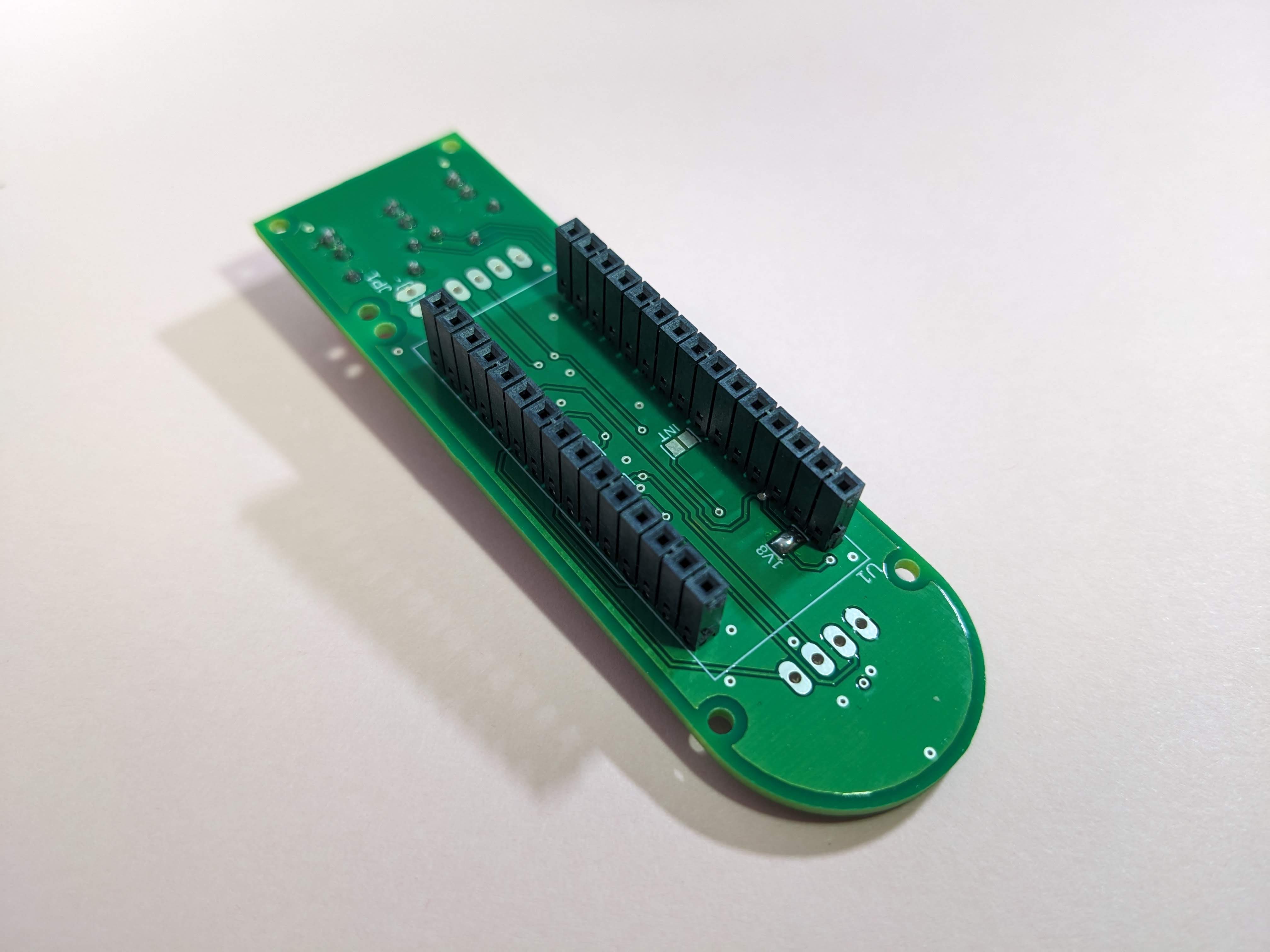 The underside of the PCB with the Arduino Nano headers and 1V8 solder short added.