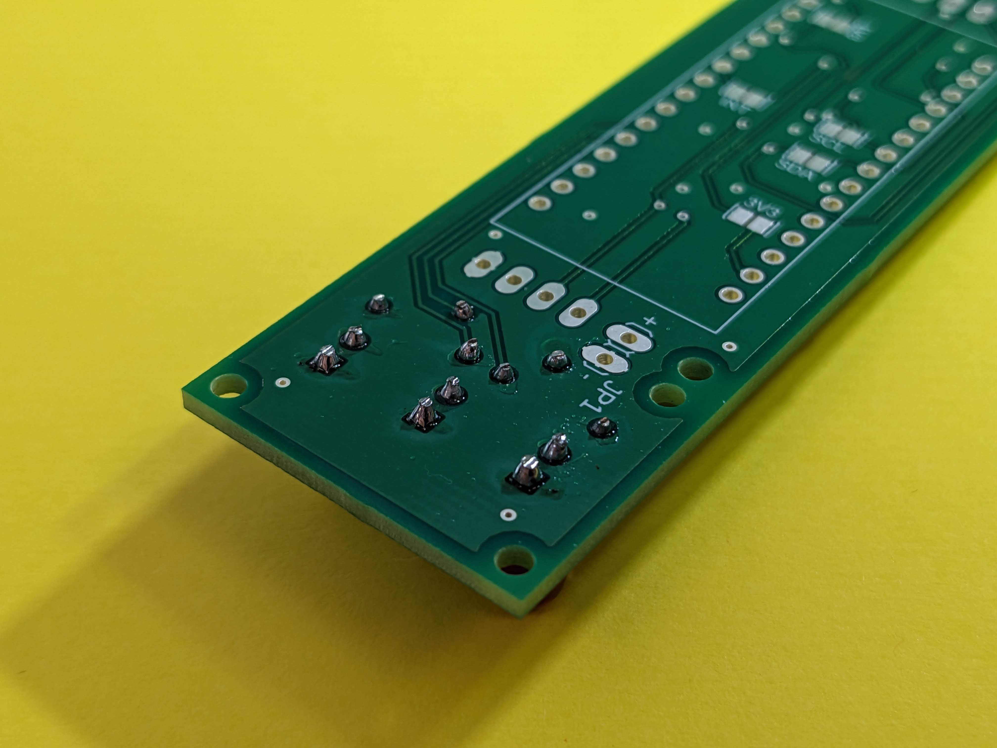 The underside of the PCB with the through-hole resistors and LEDs soldered in place.