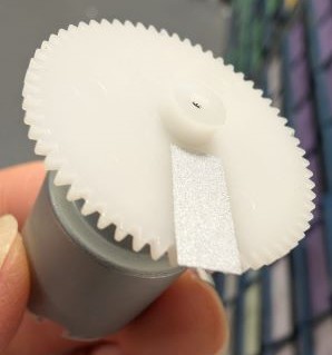 White plastic gear wheel for speed measurement.